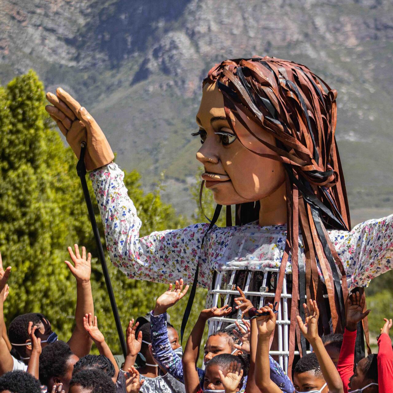 Little Amal with children in Cape Town